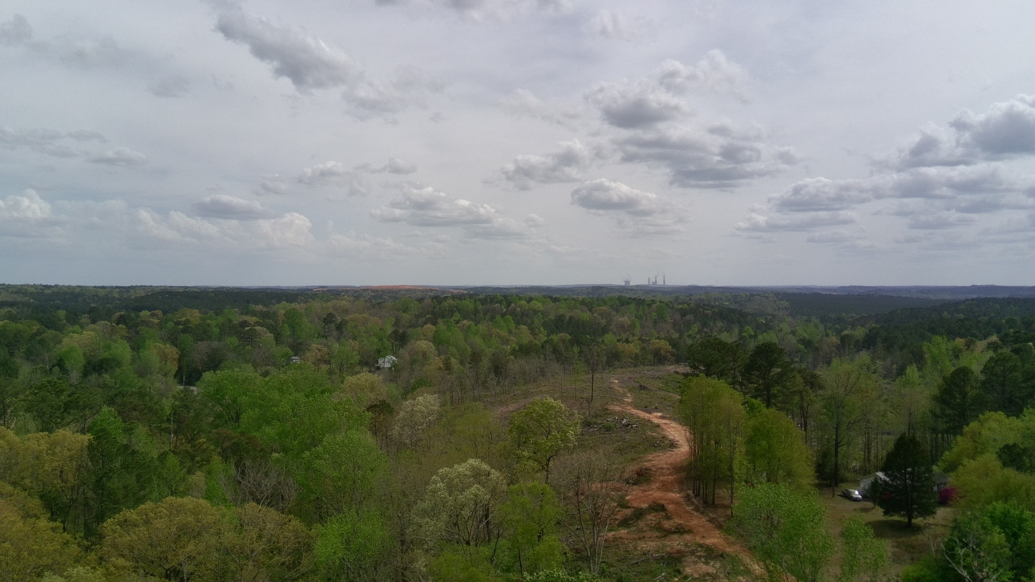 Aerial view across the Dora Alabama property showing long ridge views and surrounding wooded hills